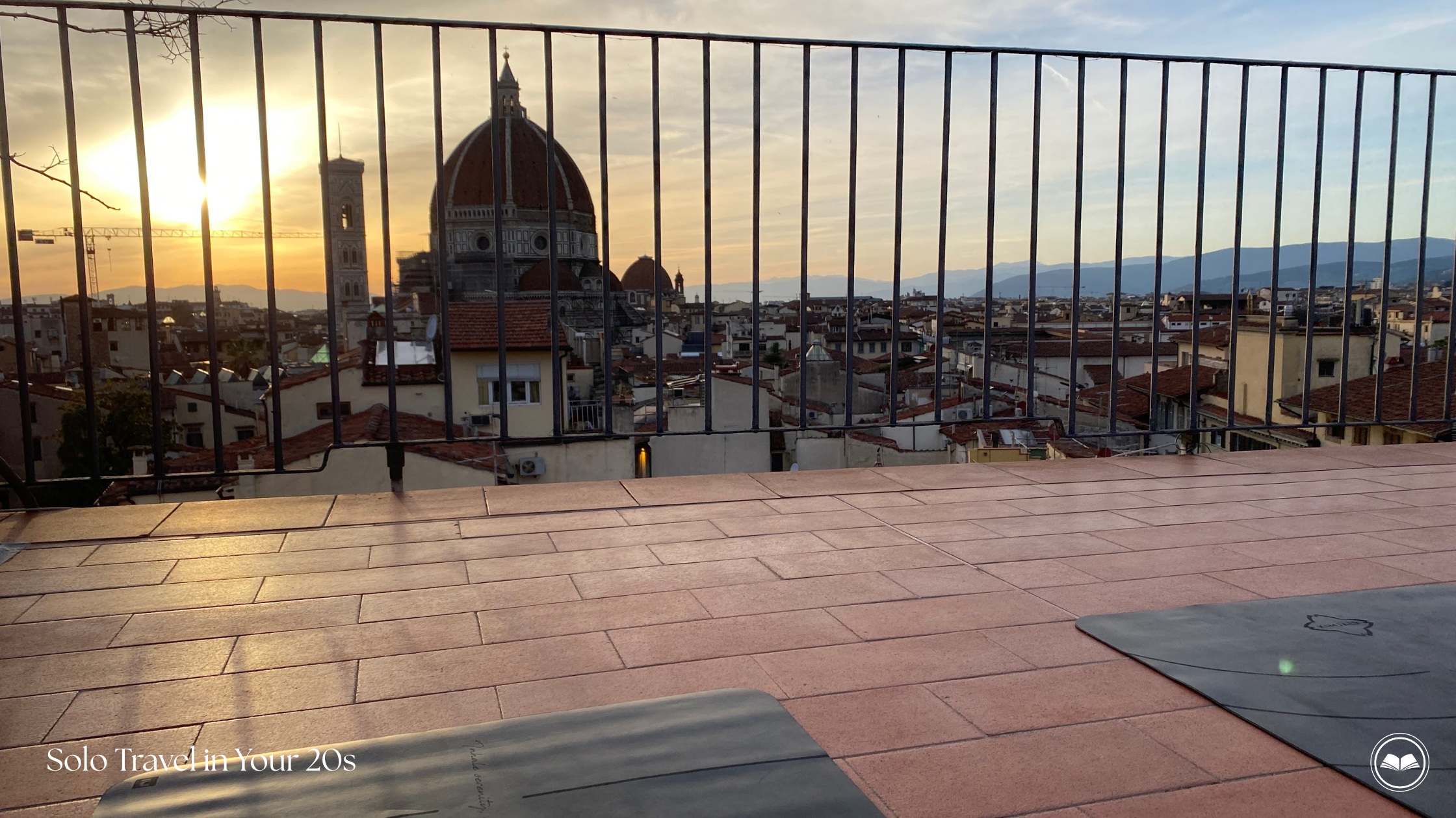 Solo traveler in her 20s attending a yoga class in Florence, Italy with a view of the Florence Cathedral